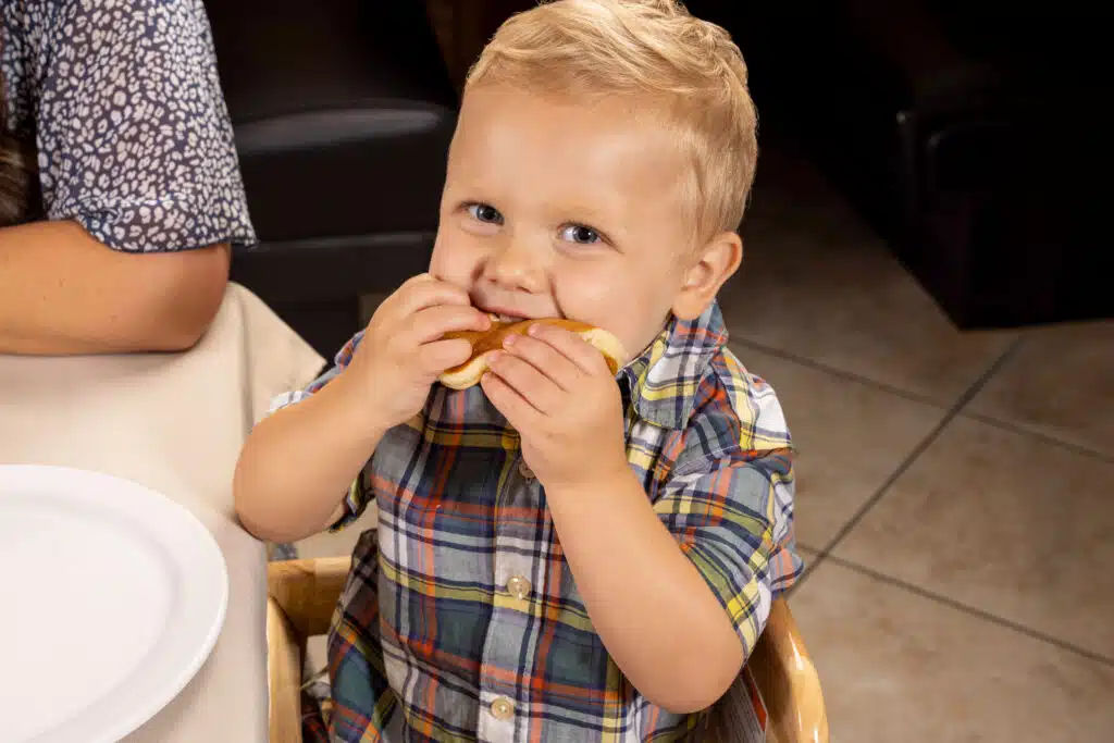 Happy young child eating a kid-friendly breakfast item at Hungry Jack's, a family-friendly restaurant in the Houston area